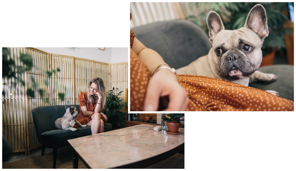 Goldsmith sitting on a couch in the studio of Bobini Roots with her french bulldog